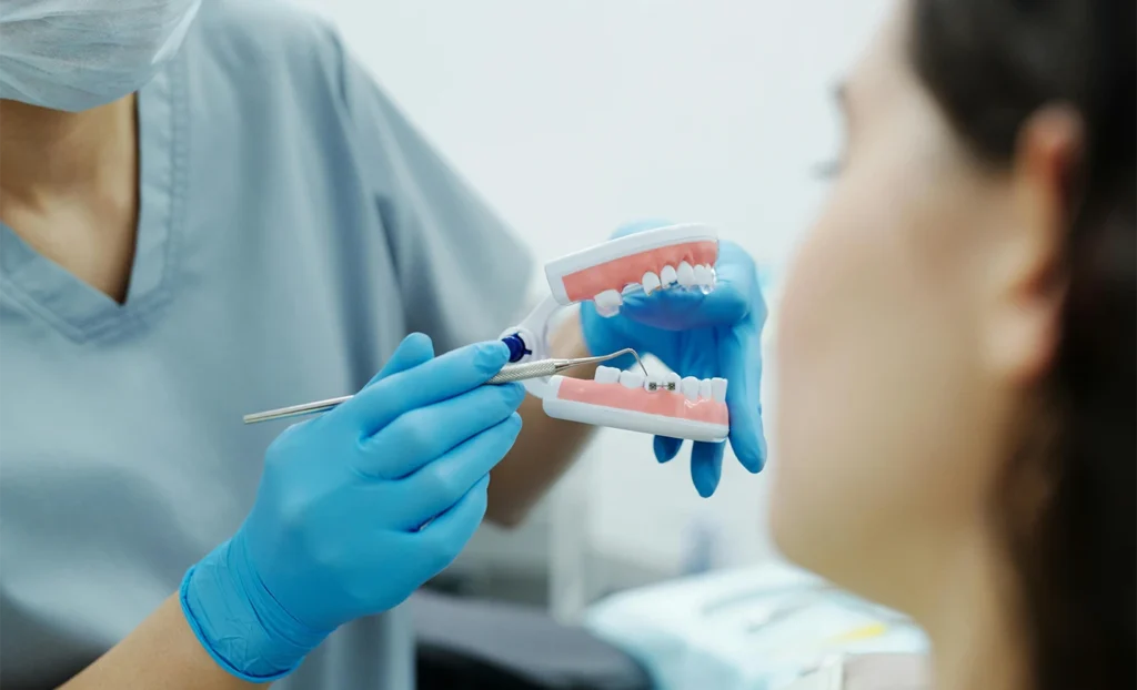 dentist discussing dental implant and bridge options in london