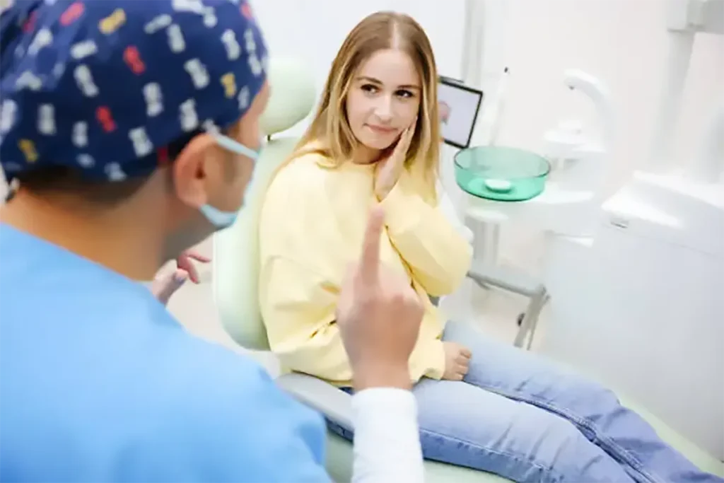 dentist consulting with girl suffering toothach