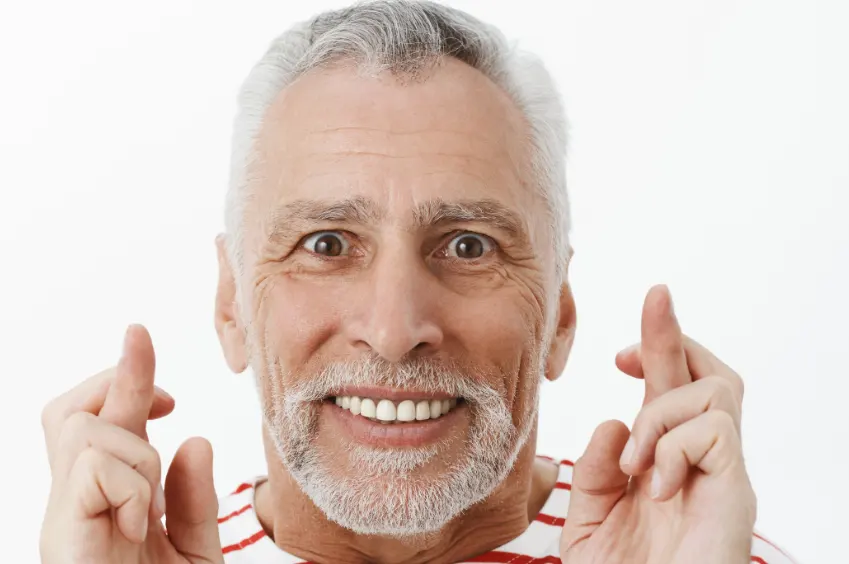 happy old man after dental implant treatment