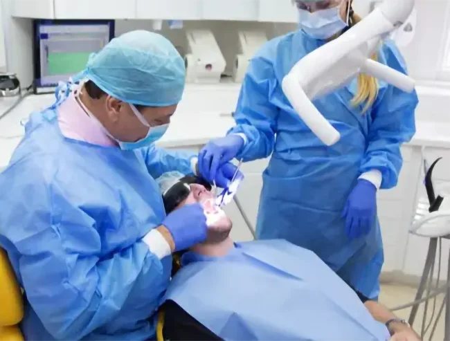 dentist performing dental treatment at Winchmore Hill Dental Practice