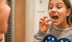 girl feeling her tooth loose